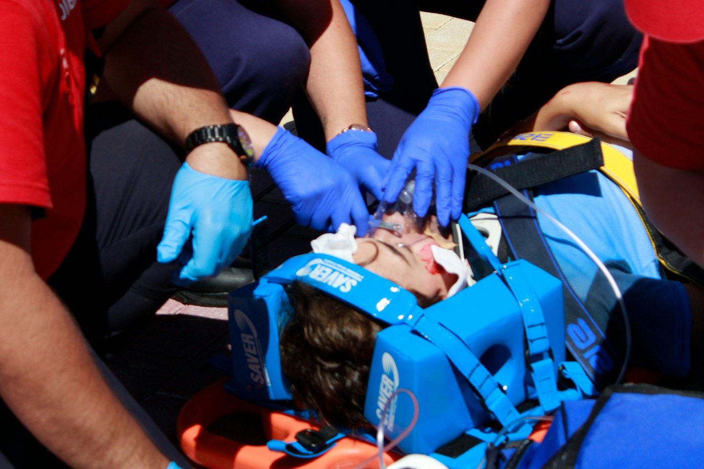 Someone treating a minor injury outdoors with a first aid kit during a hike